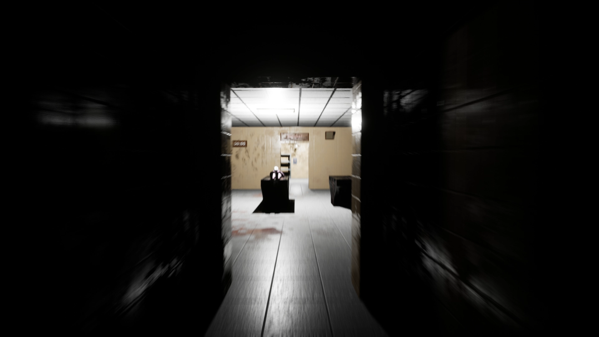 Dark corridor opening onto a lit mortuary office